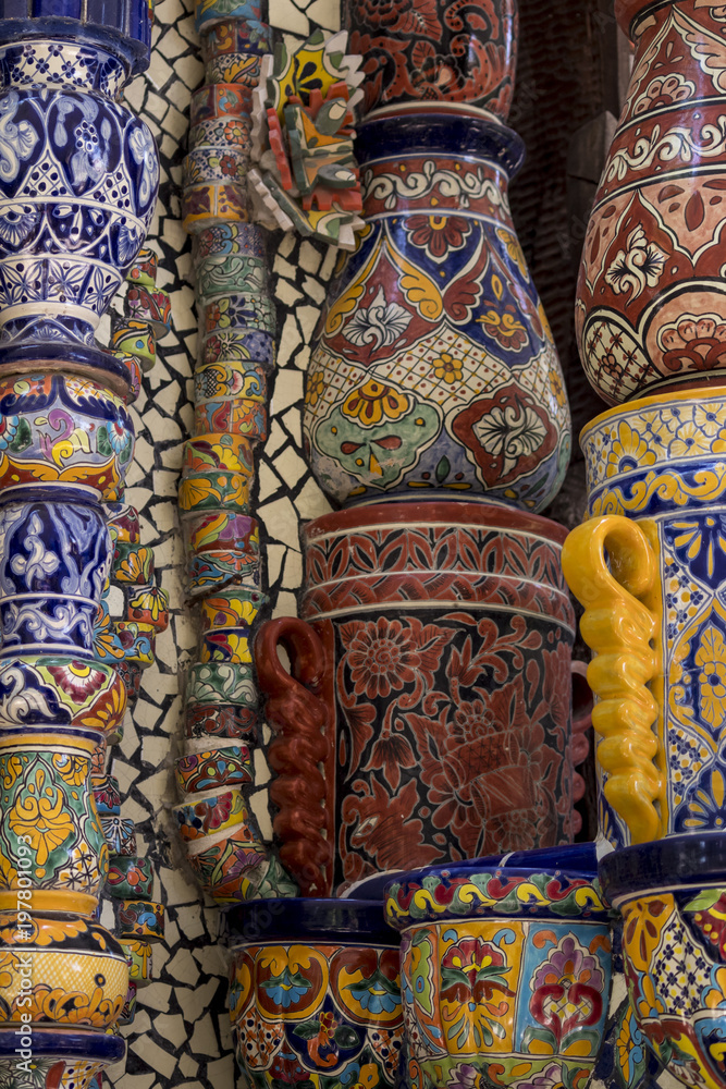 Fototapeta premium Mexican talavera style pottery used in altar and fountain. This colorful handmade maiolica have a blurred appearance as they fuse slightly into the glaze. Vibrant colors and unique designs in each one