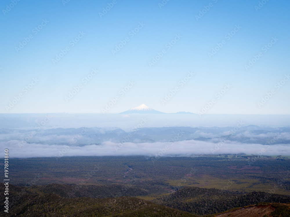 Solitary Snow Capped Volcano Mountain Poking Through Clouds Mt Taranki, New Zealand
