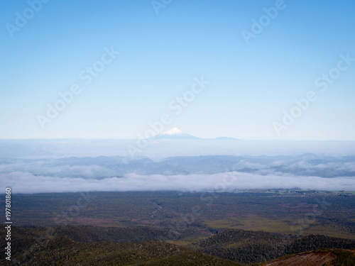 Solitary Snow Capped Volcano Mountain Poking Through Clouds Mt Taranki  New Zealand