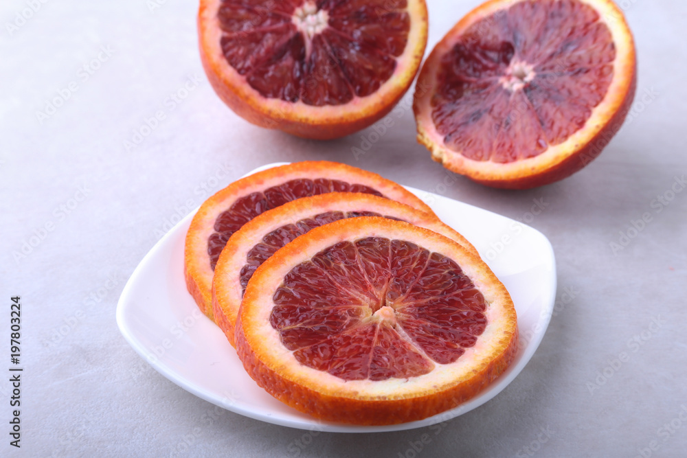 Orange fruit. Orange and lemon slice on white plate. Top view. Orange fruit. Orange and lemon slice on white plate. Top view.
