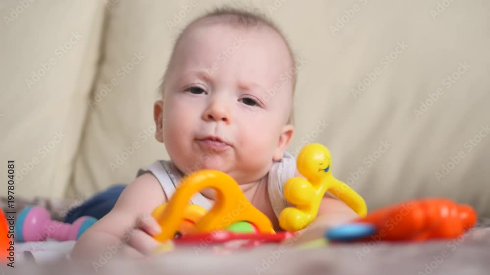 Funny little child playing with toys by the home Funny little child playing with toys by the home