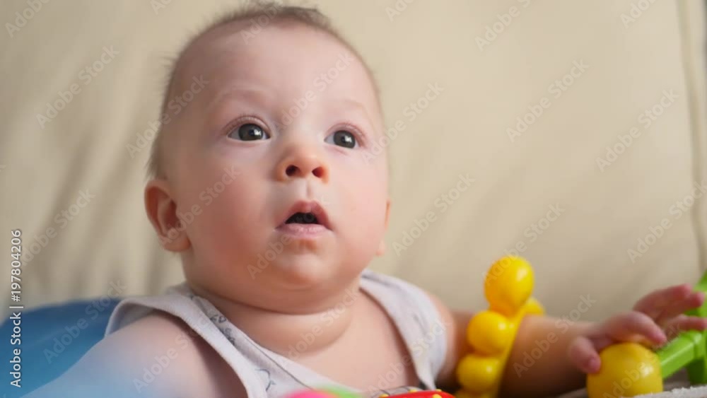 Funny little child playing with toys by the home Funny little child playing with toys by the home