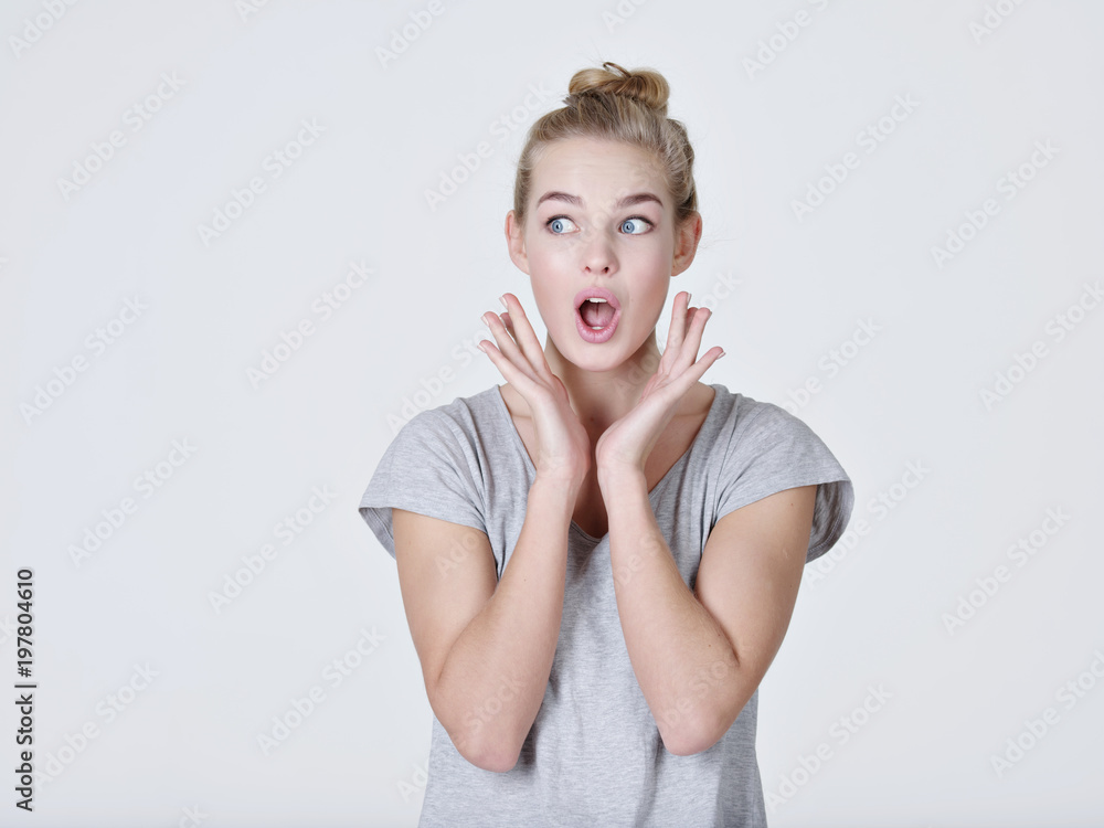 Young shocked woman on white background Young shocked woman on white background