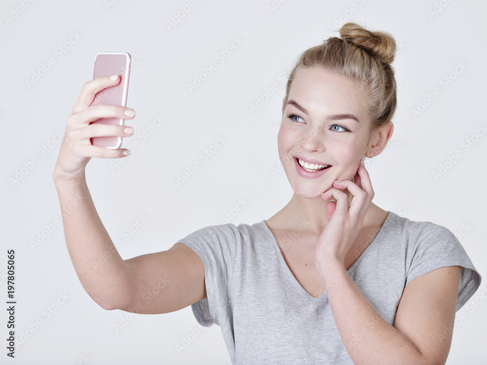Young caucasian girl makes selfies Young caucasian girl makes selfies