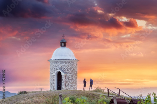 Chapel with pair of people during beautiful sunset in South Moravia