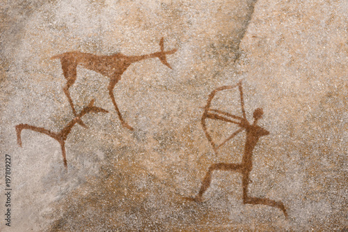 a drawing of an ancient hunt on the wall of a cave of ocher. history. archeology.