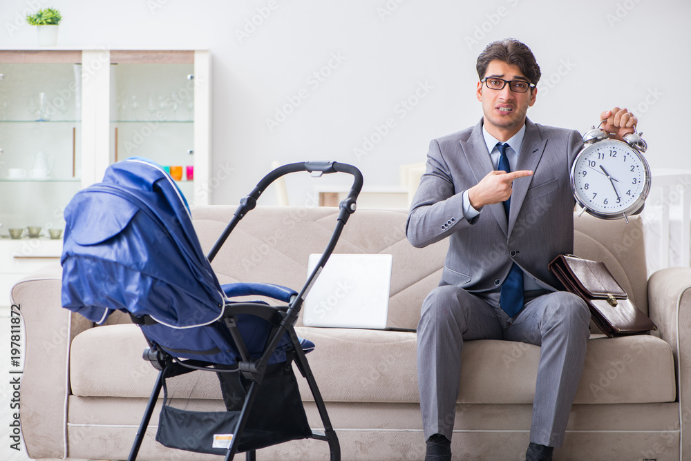 Businessman looking after newborn baby at home and teleworking Businessman looking after newborn baby at home and teleworking