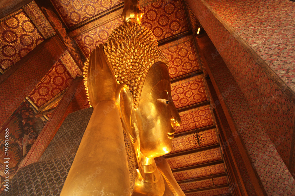 Reclining Gold Buddha statue with close up on the face. Wat Pho, Bangkok, Thailand, Asia.