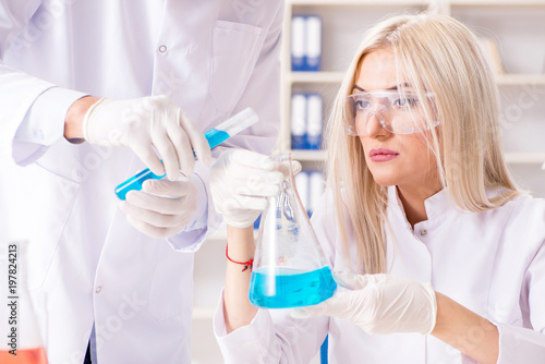 Young woman chemist working in clinic lab