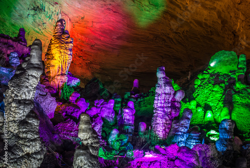Fototapeta Naklejka Na Ścianę i Meble -  beautiful illuminated multicolored stalactites from karst Reed Flute cave. Guilin Guangxi  China