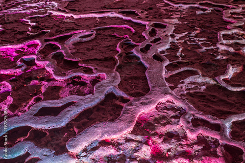 Violet ice cave covered with snow and flooded  