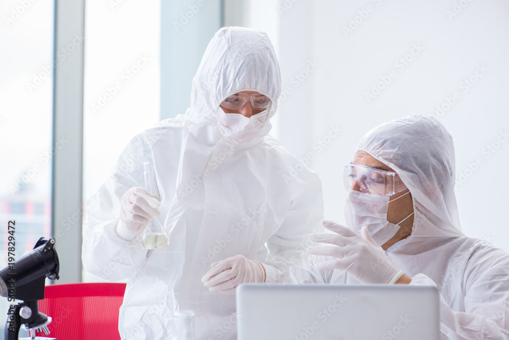 Two scientists working in the chemical lab Two scientists working in the chemical lab
