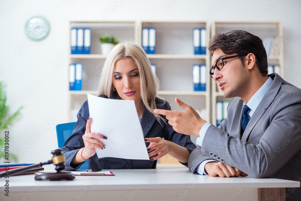 Lawyer discussing legal case with client Lawyer discussing legal case with client