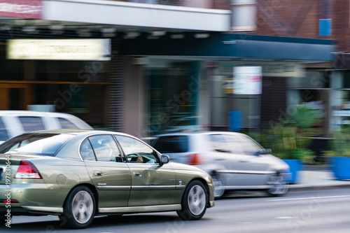 Cars in motion on the road, Sydney, Australia. Cars moving on the road, blurred buildings in background. © AVPHOTOSALES
