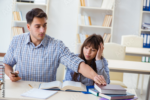 Students sitting and studying in classroom college