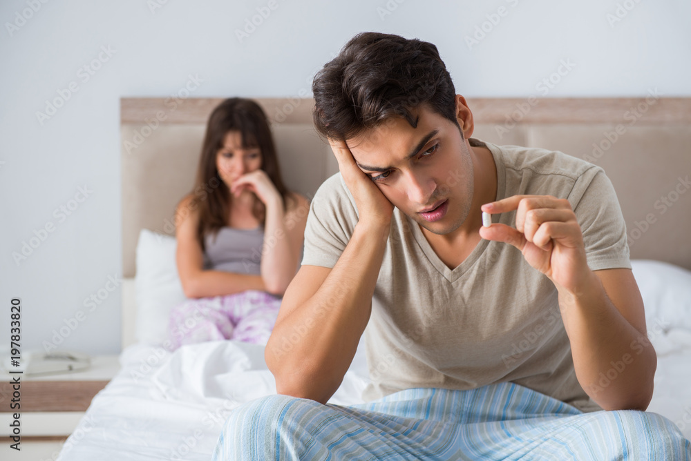 Man suffering from impotency with pill Man suffering from impotency with pill