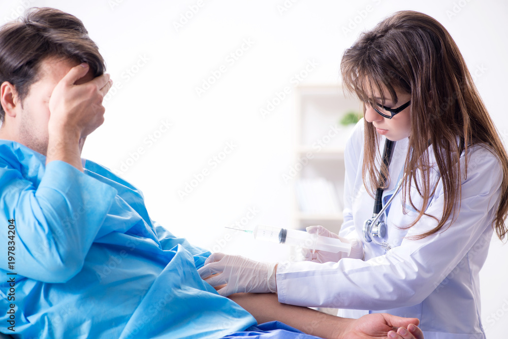 Scared patient man getting ready for flu shot Scared patient man getting ready for flu shot