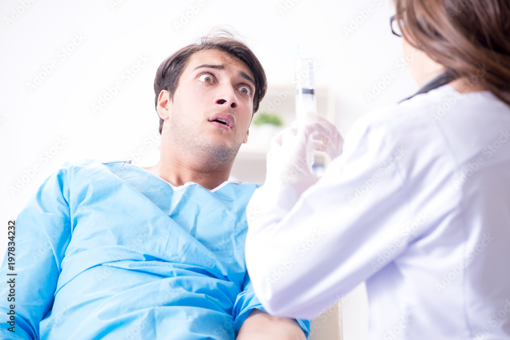 Scared patient man getting ready for flu shot Scared patient man getting ready for flu shot