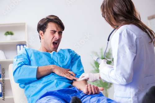 Scared patient man getting ready for flu shot