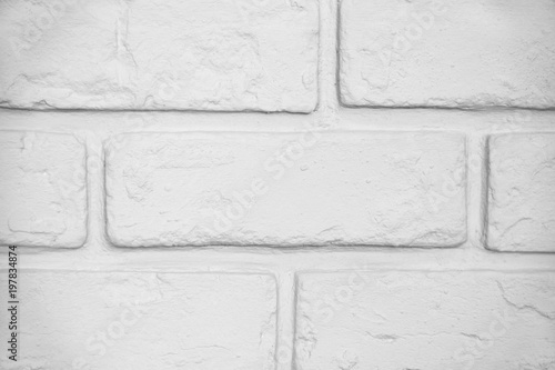 Brick wall painted white with grainy texture, aligned for backgrounds and entourage. Stucco covered with paint finish. Desaturated and processed for nuetral white balance. photo