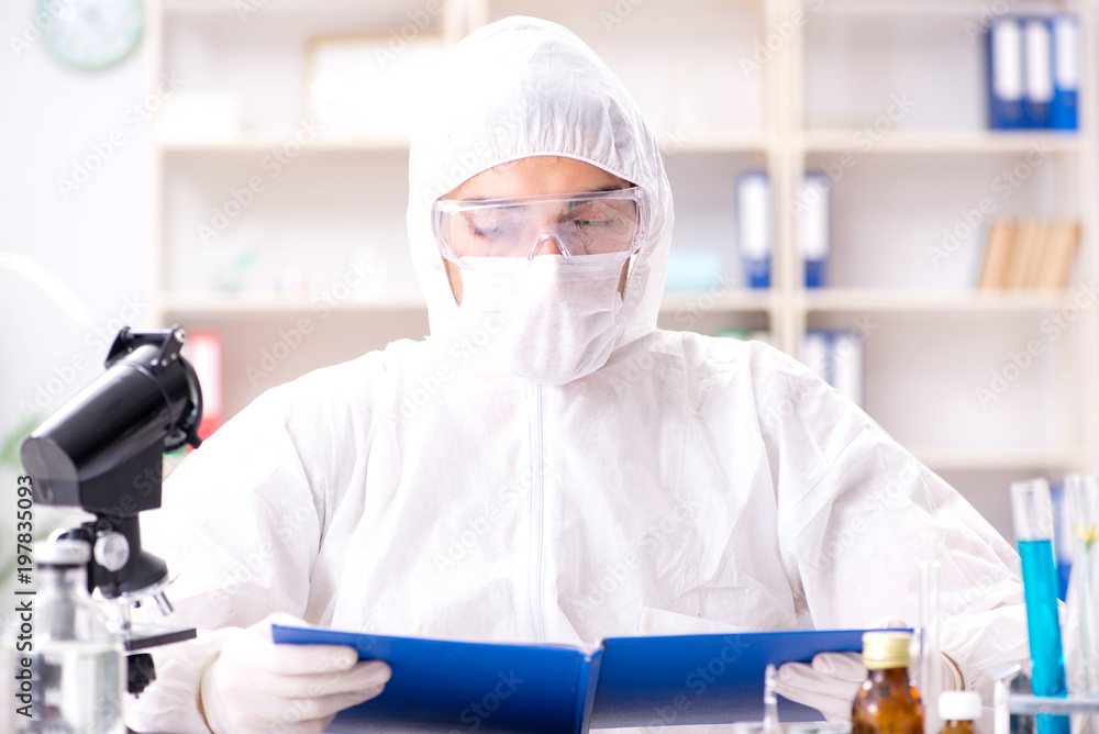 Young chemist student working in lab on chemicals Young chemist student working in lab on chemicals