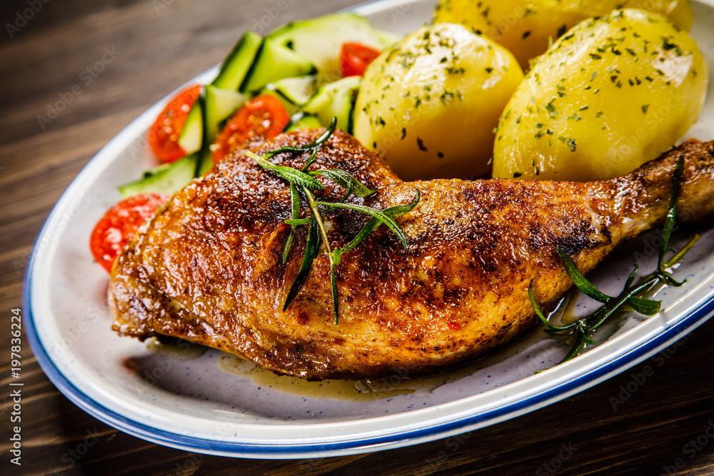 Barbecued chicken legs with boiled potatoes and vegetables Barbecued chicken legs with boiled potatoes and vegetables