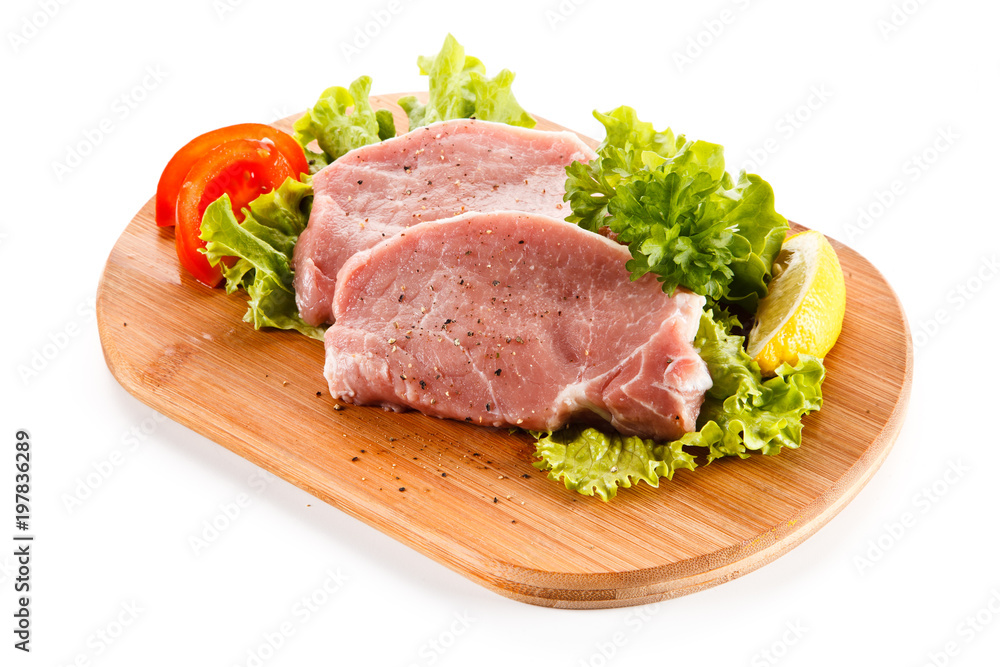 Fresh raw pork on cutting board on white background Fresh raw pork on cutting board on white background