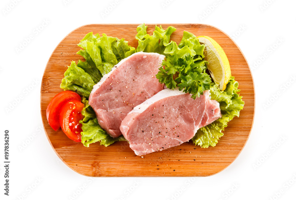 Fresh raw pork on cutting board on white background Fresh raw pork on cutting board on white background