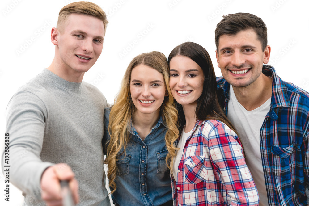 The four friends make a portrait selfie on the white background The four friends make a portrait selfie on the white background