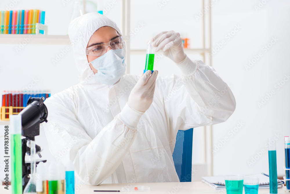Young chemist student working in lab on chemicals Young chemist student working in lab on chemicals