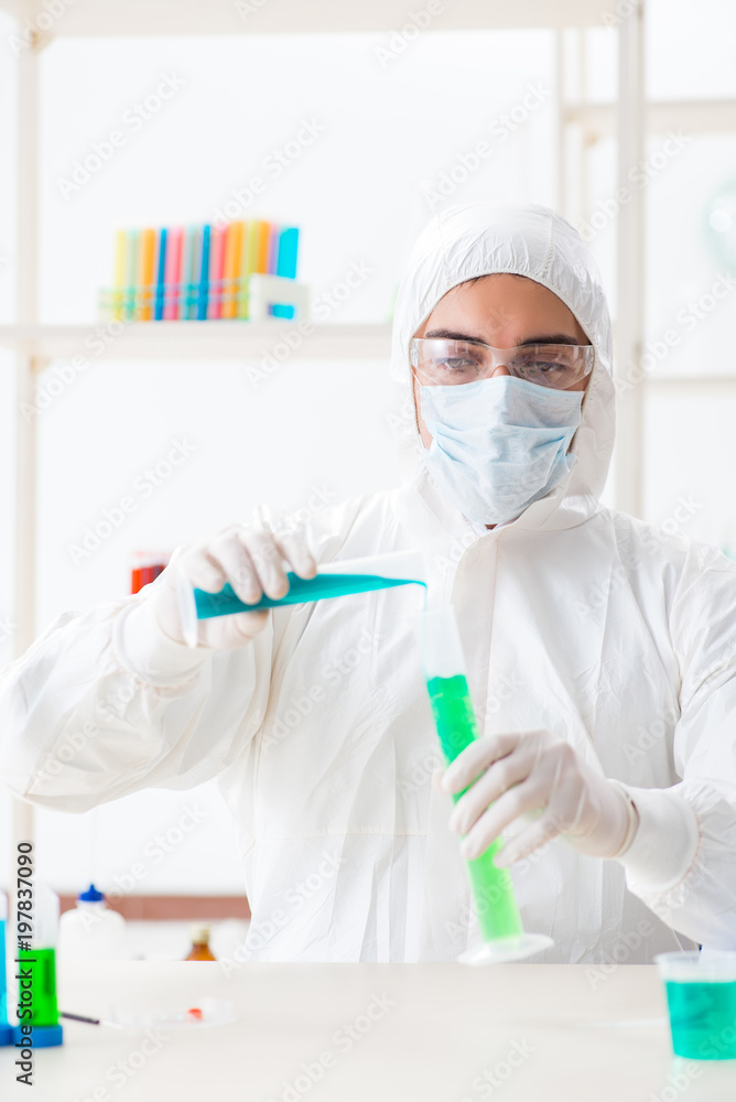 Young chemist student working in lab on chemicals Young chemist student working in lab on chemicals