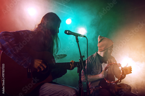 Photography The musician plays an acoustic guitar.