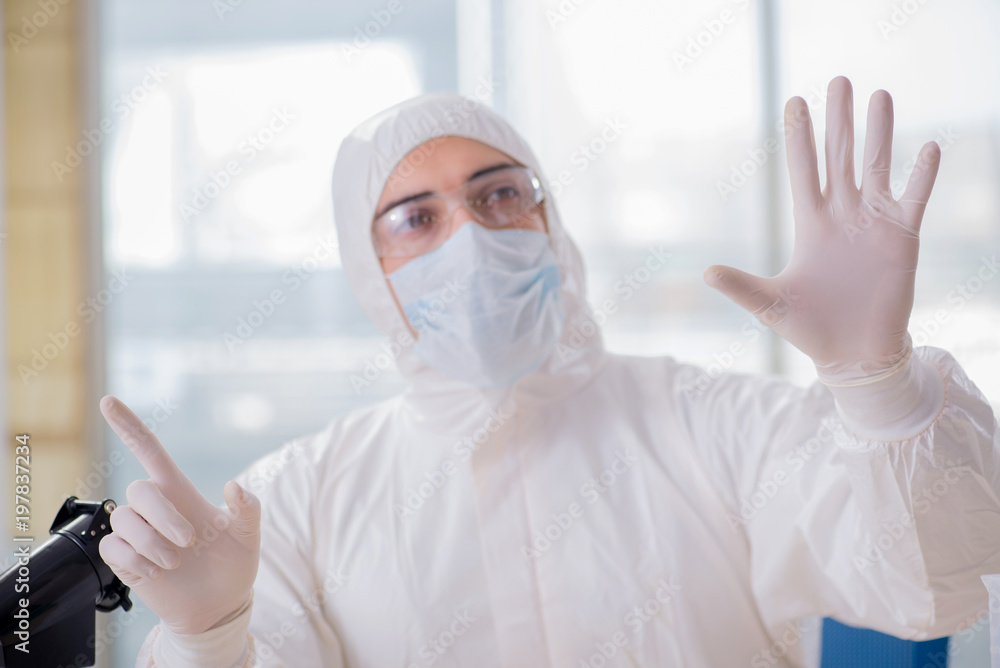 Young chemist pressing virtual buttons in lab Young chemist pressing virtual buttons in lab