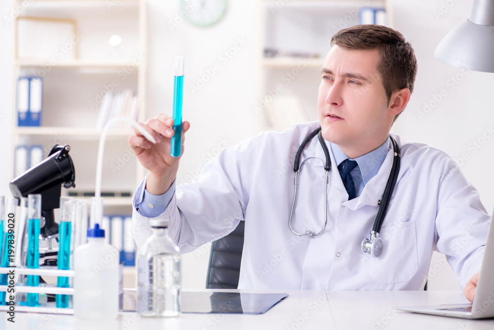 Male doctor looking at lab results in hospital Male doctor looking at lab results in hospital