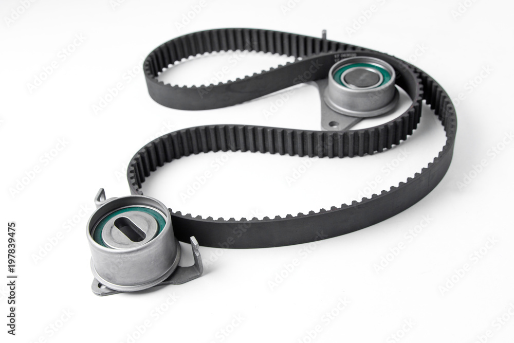 Naklejka premium Spare parts for the ca r. Kit of timing belt with rollers on a light background.