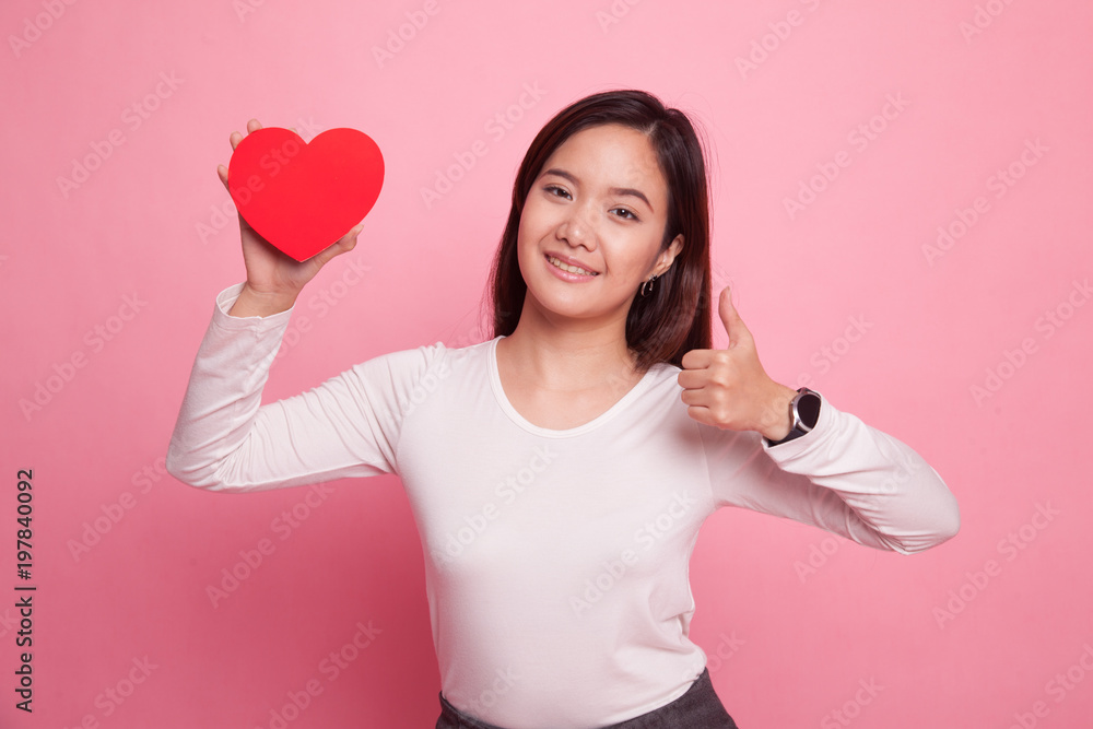 Asian woman thumbs up with red heart. Asian woman thumbs up with red heart.