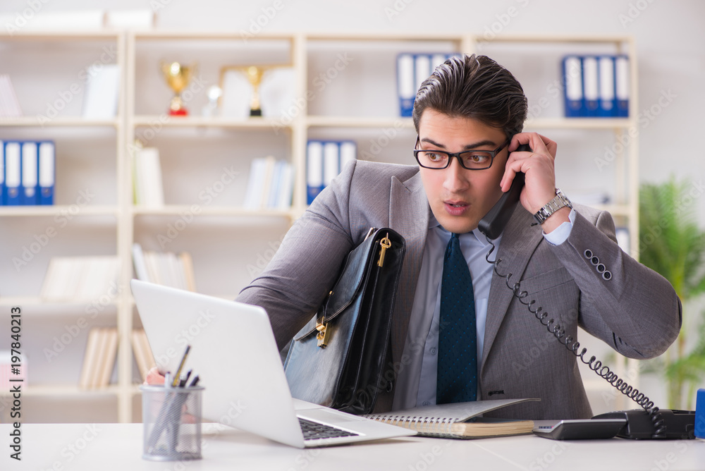 Businessman employee talking on the office phone Businessman employee talking on the office phone