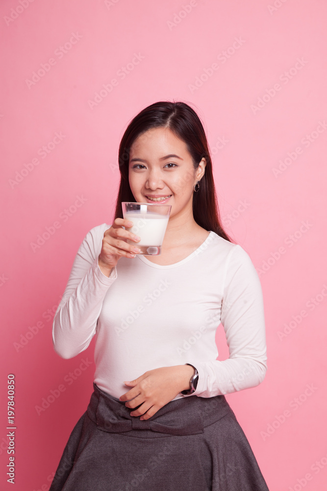 Healthy Asian woman drinking a glass of milk. Healthy Asian woman drinking a glass of milk.