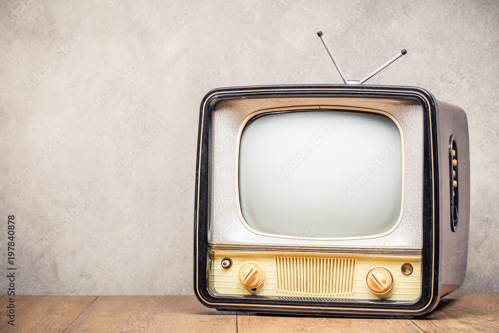 Retro old TV set receiver on table front textured concrete wall background. Broadcasting concept. Vintage style filtered photo Retro old TV set receiver on table front textured concrete wall background. Broadcasting concept. Vintage style filtered photo
