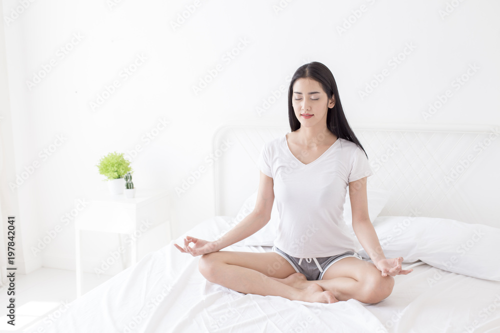Beautiful Asian woman practicing yoga on her bedroom. People with health care concept. Beautiful Asian woman practicing yoga on her bedroom. People with health care concept.