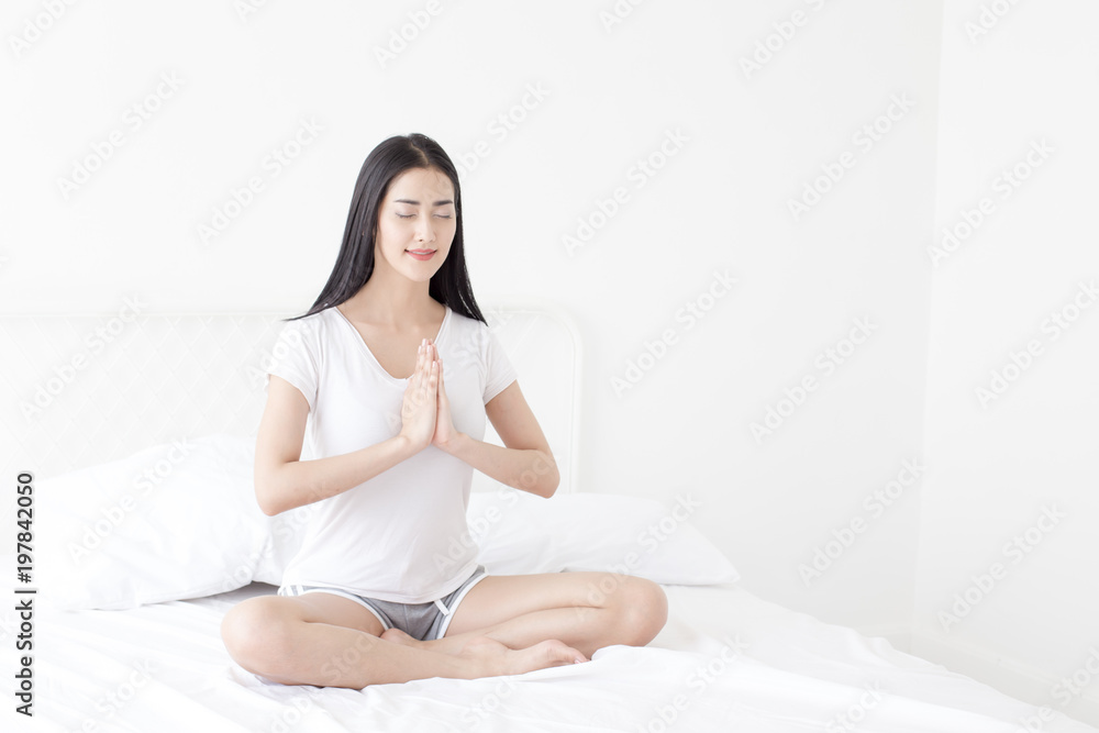 Beautiful Asian woman practicing yoga on her bedroom. People with health care concept. Beautiful Asian woman practicing yoga on her bedroom. People with health care concept.