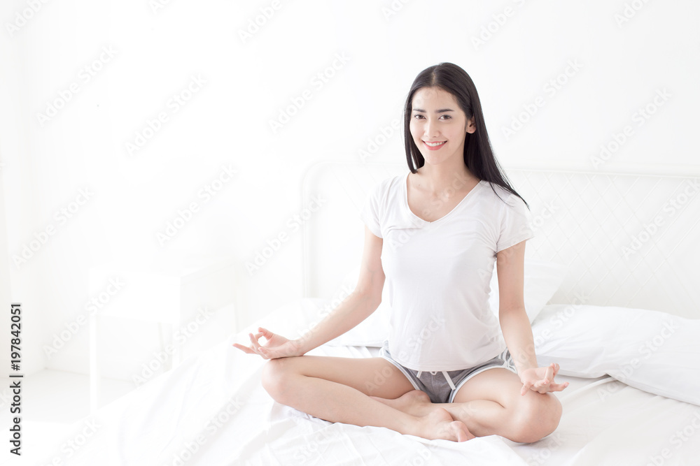 Beautiful Asian woman practicing yoga on her bedroom. Beautiful Asian woman practicing yoga on her bedroom.