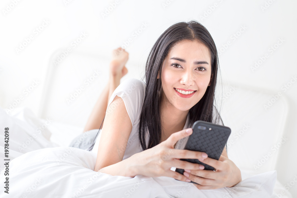 Asian woman using smartphone at home. People with technology concept. Asian woman using smartphone at home. People with technology concept.
