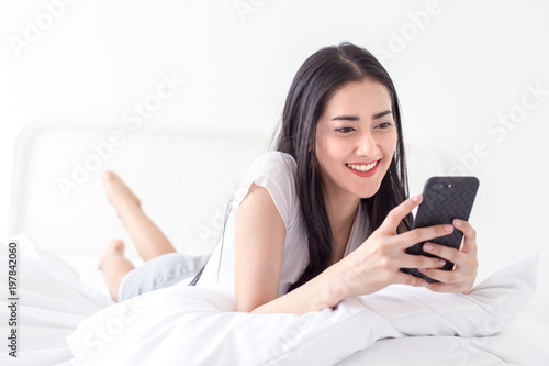 Asian woman using smartphone at home. People with technology concept.