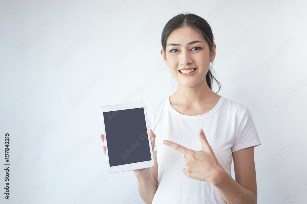 Portrait of Attractive Asian Woman using tablet with smiling on white background. Portrait of Attractive Asian Woman using tablet with smiling on white background.