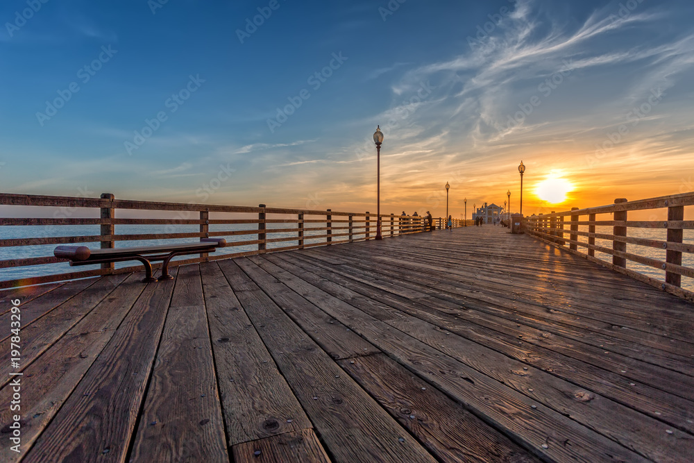 California Oceanside pier over the ocean at sunset with beach, travel destination