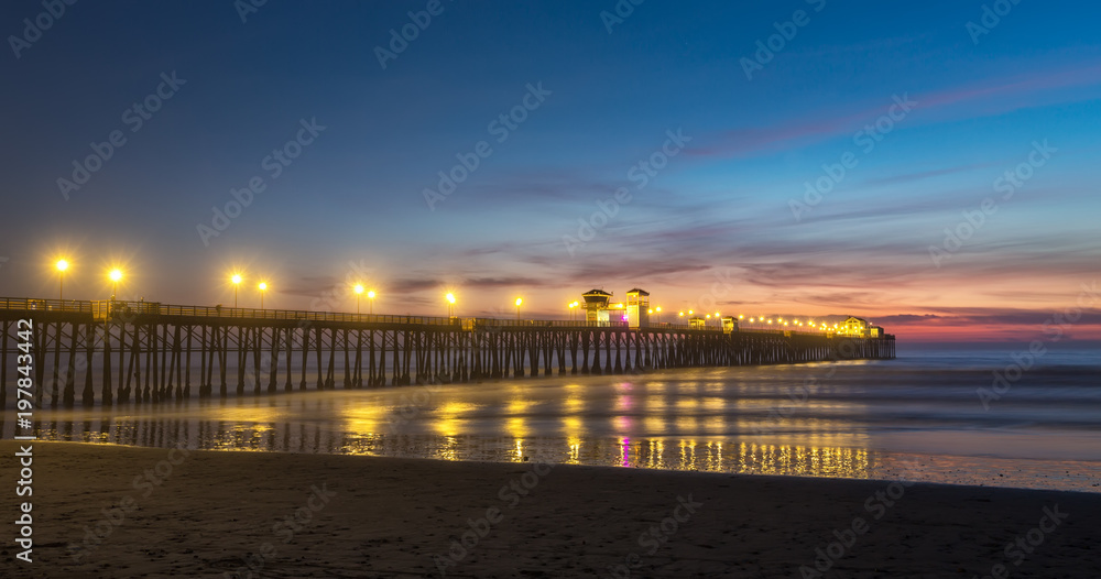 California Oceanside pier over the ocean at sunset with beach, travel destination