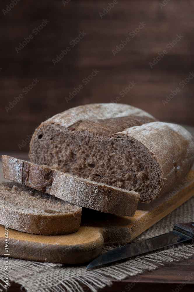 Dark Bread on wooden background vertical