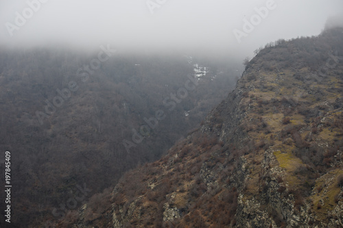 Panorama of the foggy winter landscape in the mountains with snow and rocks  Azerbaijan  Lahic  Big Caucasus