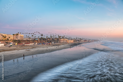 Fotografia View of the beach from the pier at sunset, in Oceanside, California
